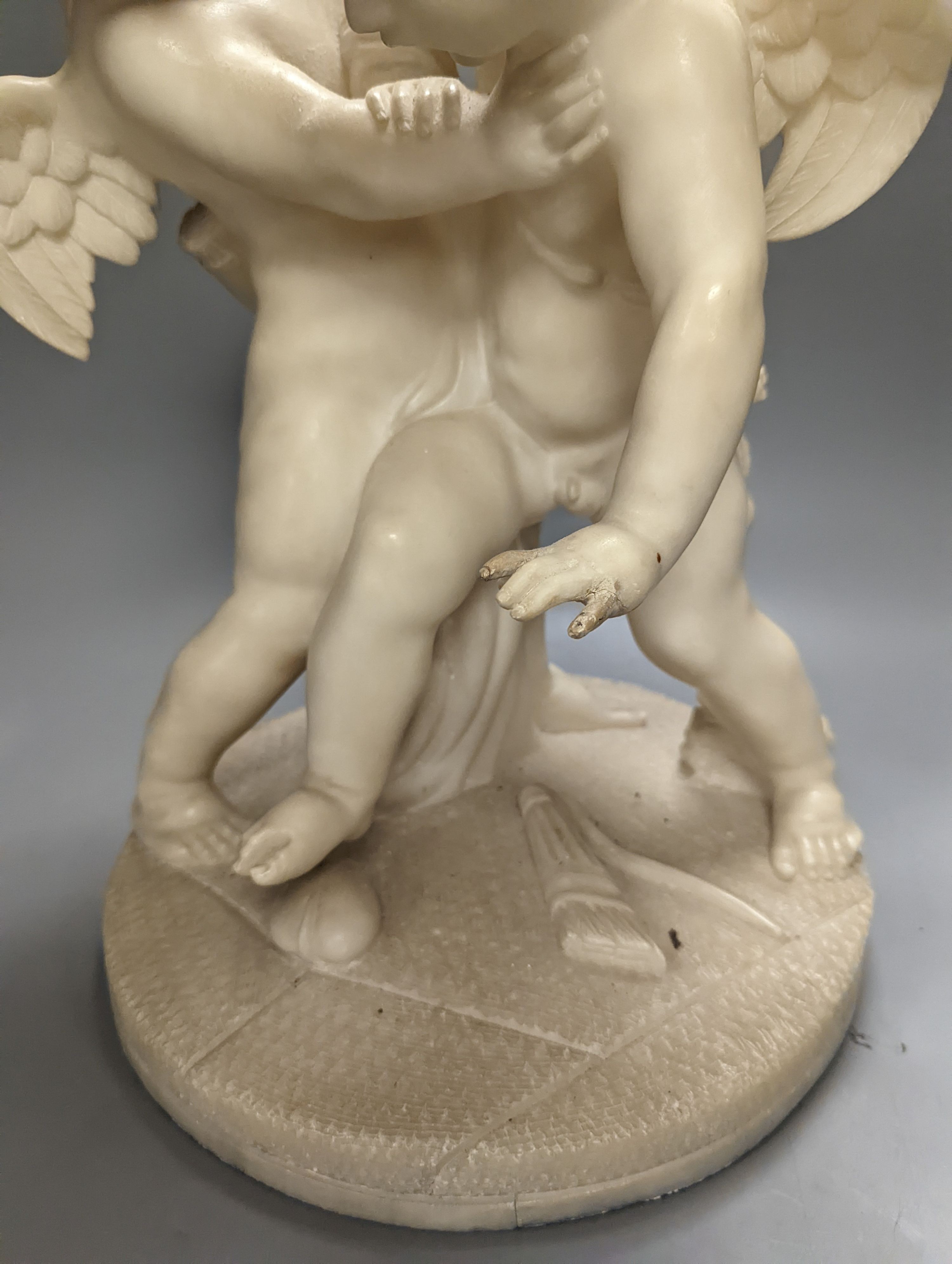 An early 20th century Italian carved alabaster cherub group, height 45cm